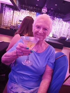 Cyndy Noel raising a cocktail at Cape Cabaret