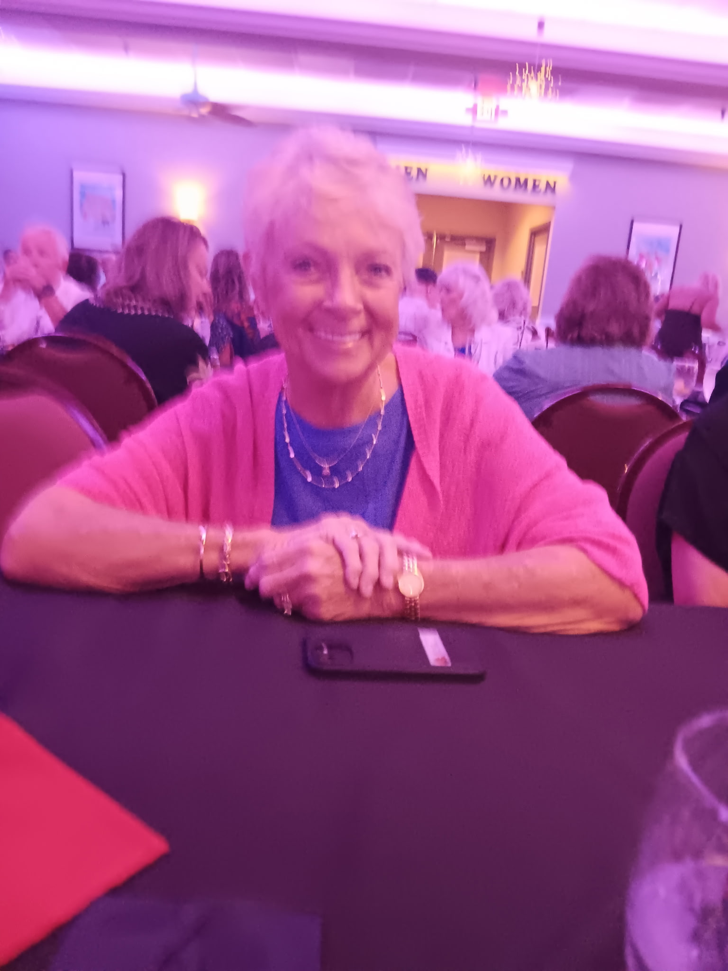Helen Cotner seated at her table at the Queen Tribute show