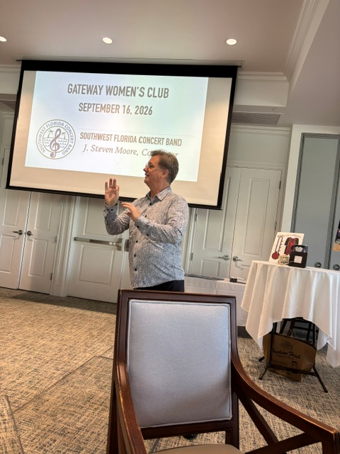 Dr. Moore conducting the group in front of a presentation screen
