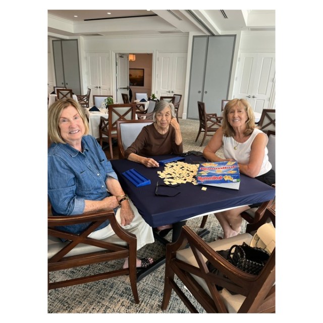 Three Gateway Women’s Club members playing Rummikub at a table