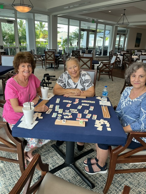 Three Gateway Women’s Club members mid-game at a Rummikub table