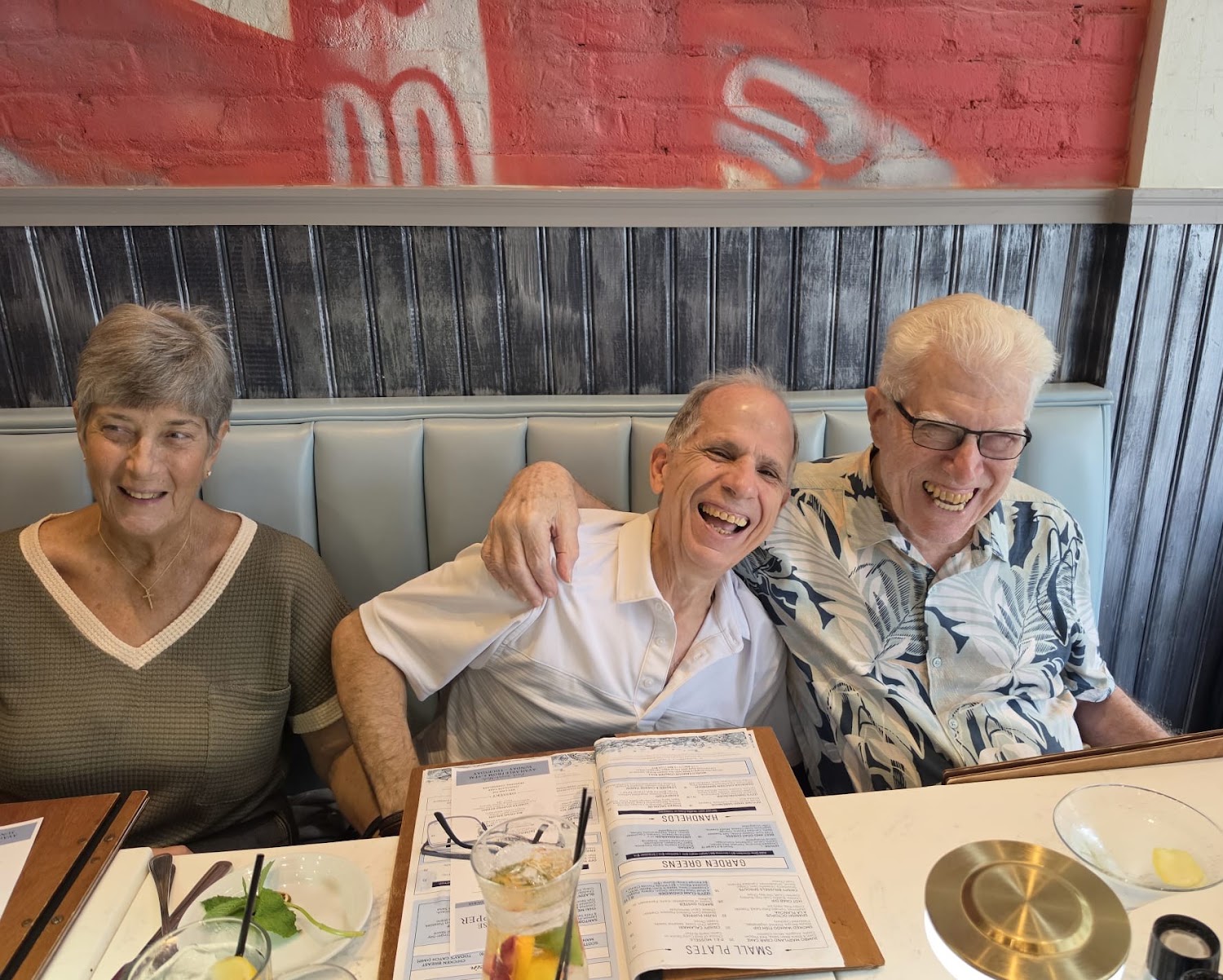 Three diners in a restaurant booth