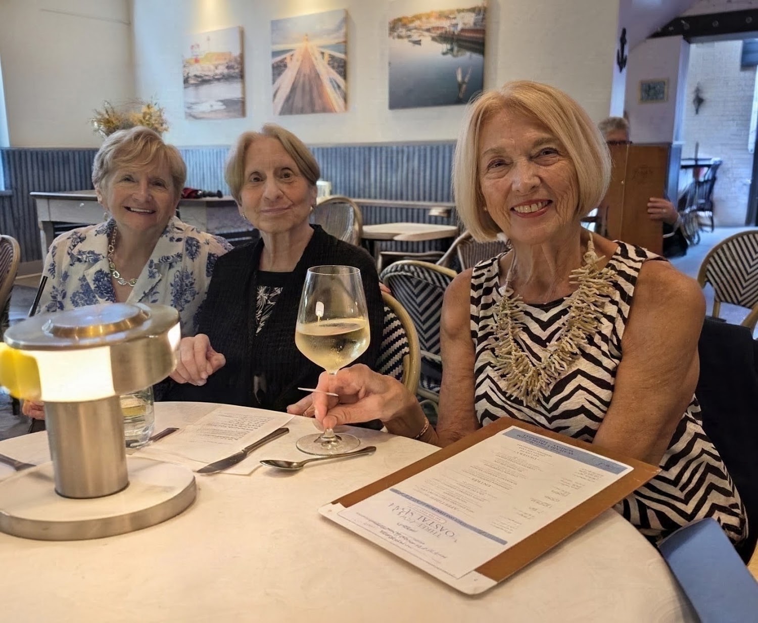 Three women raising a toast at dinner