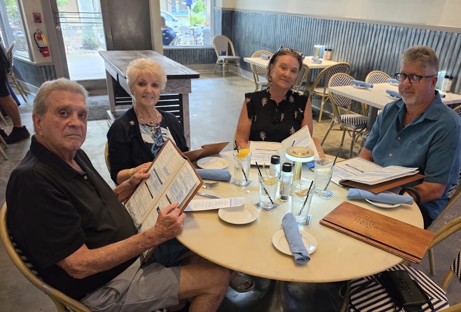 Four diners around a round restaurant table