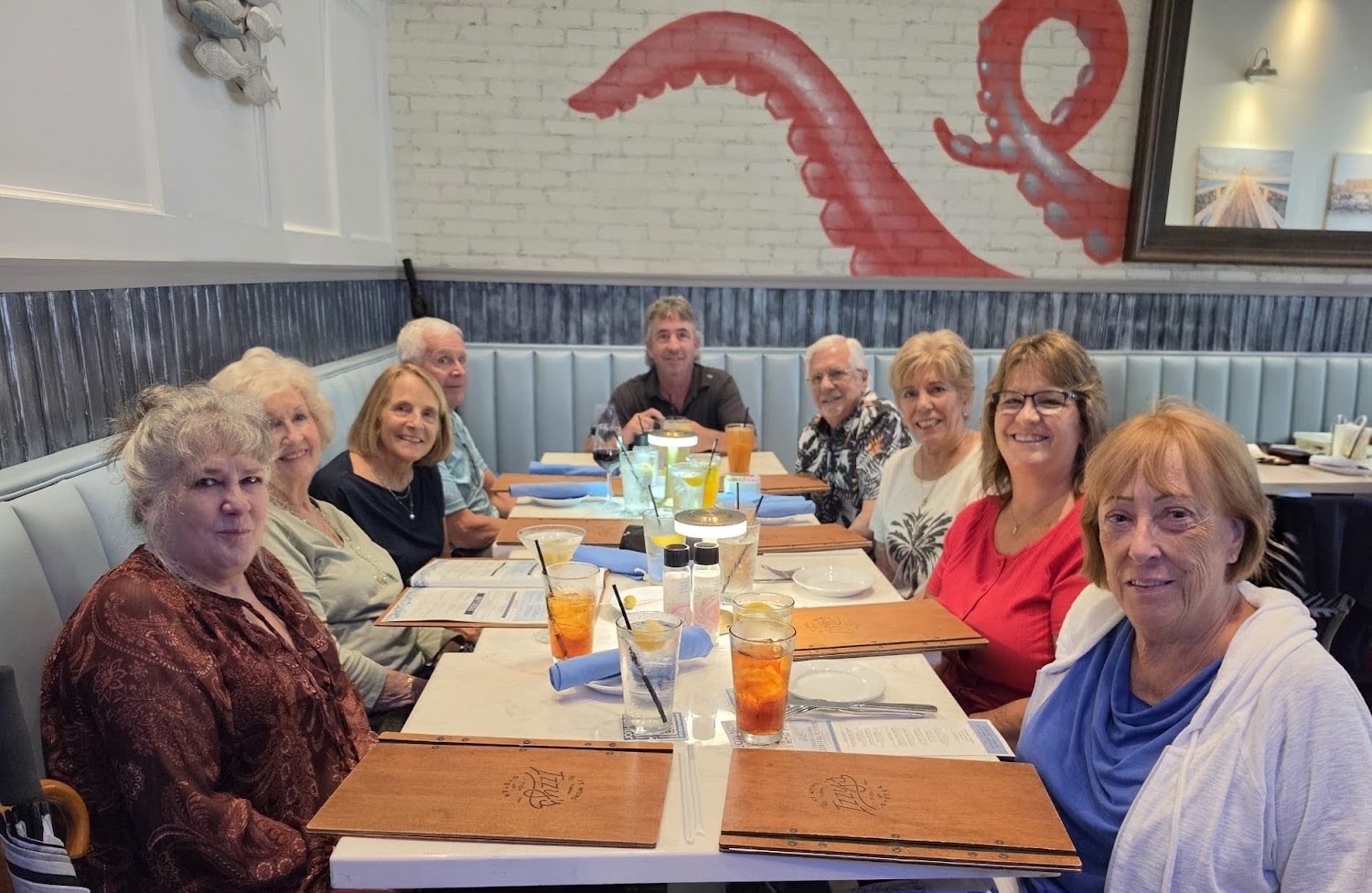 A long table of club members and guests at dinner
